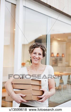 Woman with four packages in her arms View Large Photo Image Stock Photo - Woman with four packages in her arms. Fotosearch