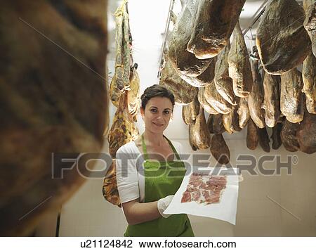 Woman with freshly cut ham View Large Photo Image Stock Image - Woman with freshly cut ham. Fotosearch