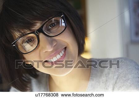 Woman with glasses, smiling at camera View Large Photo Image Stock Photo - Woman with glasses, smiling at camera. Fotosearch