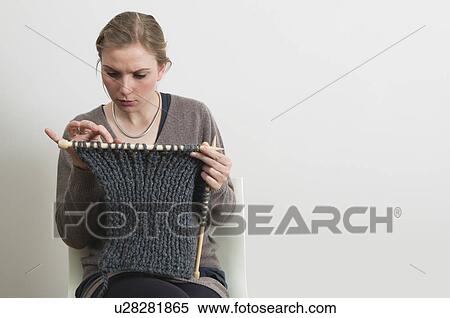 Stock Photography - Woman with knitting counting stitches. Fotosearch