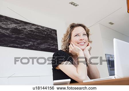 Woman with laptop thinking View Large Photo Image Stock Photograph - Woman with laptop thinking. Fotosearch