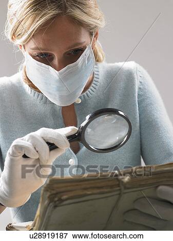 Woman with mask and magnifying glass View Large Photo Image Stock Photo - Woman with mask and magnifying glass. Fotosearch