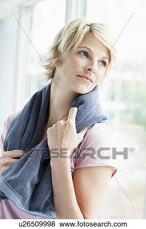 Woman with towel looking out window View Large Photo Image Stock Photo - Woman with towel looking out window. Fotosearch