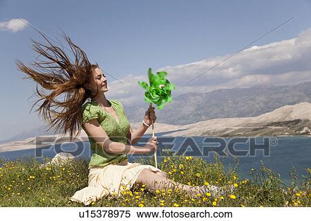 Woman with wind wheel by sea View Large Photo Image Stock Photography - Woman with wind wheel by sea. Fotosearch