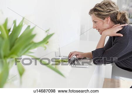 Stock Photo - Woman working with laptop. Fotosearch