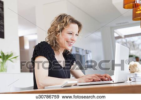Woman working with laptop View Large Photo Image Stock Photo - Woman working with laptop. Fotosearch