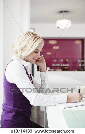 Woman writing at cafe View Large Photo Image Stock Image - Woman writing at cafe. Fotosearch