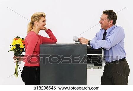 Stock Photography - Women about to surprise man with flowers. Fotosearch