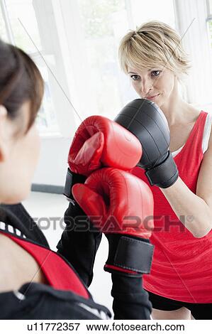 Stock Photo - Women boxing against each other. Fotosearch