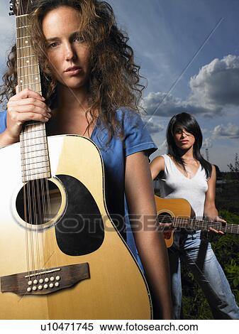 Stock Photography - Women holding guitars. Fotosearch