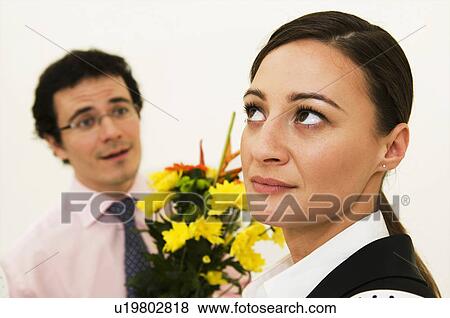 Women ignores man offering flowers View Large Photo Image Stock Photo - Women ignores man offering flowers. Fotosearch