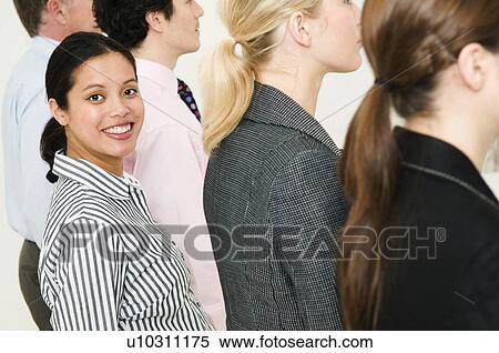 Women in line of people smiles to camera View Large Photo Image Stock Photography - Women in line of people smiles to camera. Fotosearch