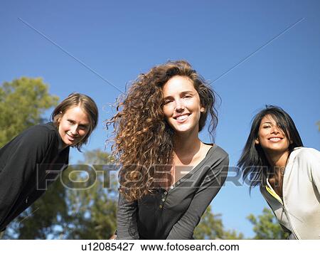 Women looking into the camera, smiling View Large Photo Image Stock Photo - Women looking into the camera, smiling. Fotosearch