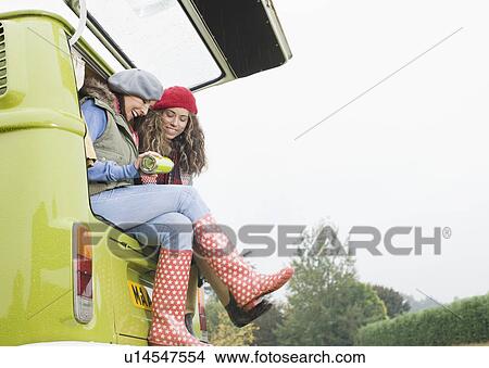 Picture - Women sharing hot drink. Fotosearch