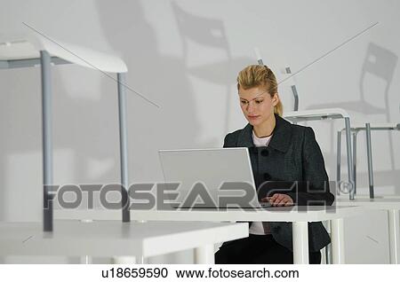 Stock Image - Women works late. Fotosearch