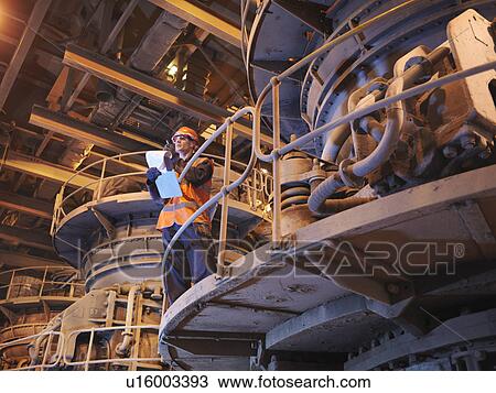 Stock Image - Worker In Coal Fired Power Station. Fotosearch