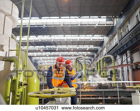 Stock Image - Workers In Coal Fired Power Station. Fotosearch