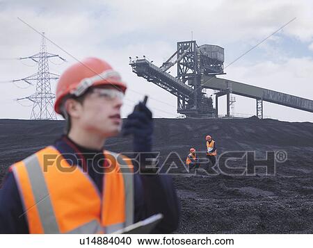 Stock Image - Workers In Coal Store In Power Station. Fotosearch