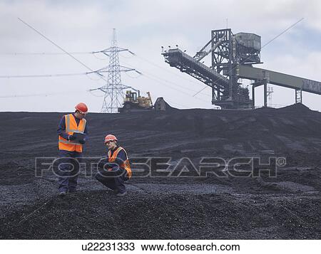 Stock Image - Workers In Coal Store In Power Station. Fotosearch