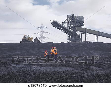 Stock Image - Workers Inspecting Coal Store. Fotosearch