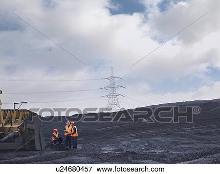 Stock Photo - Workers Inspecting Coal Store. Fotosearch
