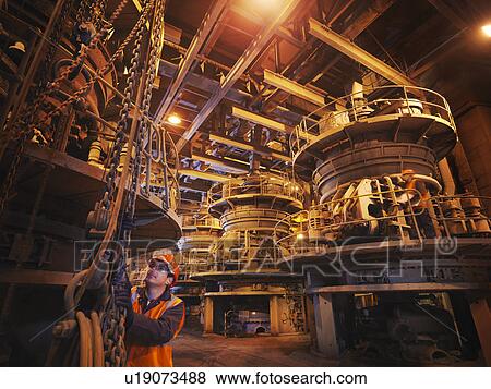 Stock Photo - Workers Milling Coal In Power Station. Fotosearch