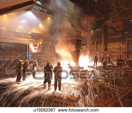 Stock Photo - Workers With Molten Steel In Plant. Fotosearch