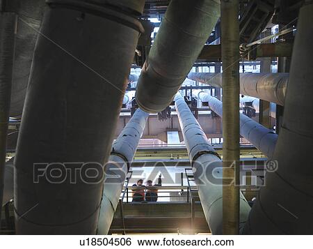 Stock Photograph - Workers With Pipes In Power Station. Fotosearch