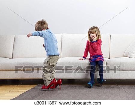Young boy and girl walking in high-heels View Large Photo Image Stock Photo - Young boy and girl walking in high-heels. Fotosearch