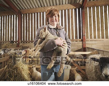 Picture - Young Boy Holding Lamb. Fotosearch