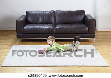 Young boy putting coins in piggy-bank View Large Photo Image Stock Photo - Young boy putting coins in piggy-bank. Fotosearch