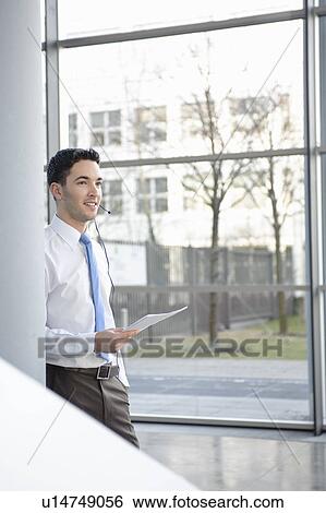 Young business man in office, headset View Large Photo Image Stock Photograph - Young business man in office, headset. Fotosearch