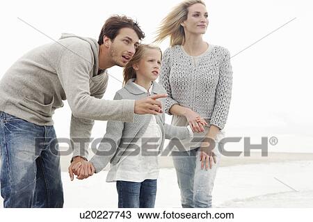 Young family on beach in autumn View Large Photo Image Stock Image - Young family on beach in autumn. Fotosearch