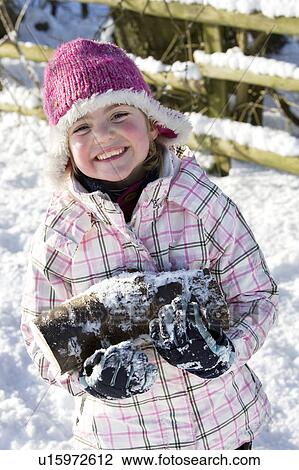 Young girl carrying logs in the snow View Large Photo Image Stock Image - Young girl carrying logs in the snow. Fotosearch