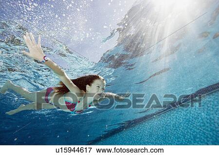 Stock Photo - Young girl in swimming pool. Fotosearch