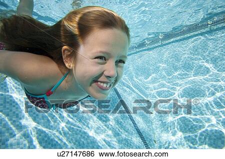 Young girl in swimming pool View Large Photo Image Stock Photograph - Young girl in swimming pool. Fotosearch