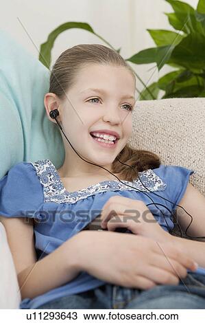 Young girl wearing head phones View Large Photo Image Stock Image - Young girl wearing head phones. Fotosearch