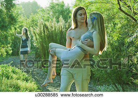 Young man carrying young woman View Large Photo Image Stock Photography - Young man carrying young woman. Fotosearch