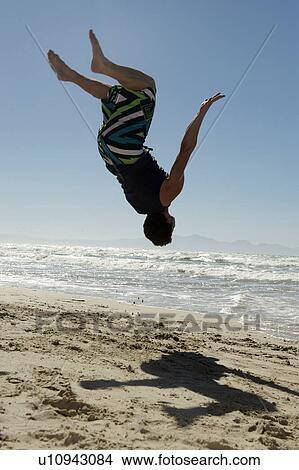 Young man doing back flip View Large Photo Image Picture - Young man doing back flip. Fotosearch