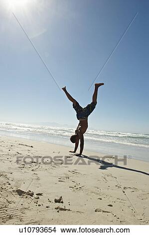 Young man doing hand stands View Large Photo Image Picture - Young man doing hand stands. Fotosearch