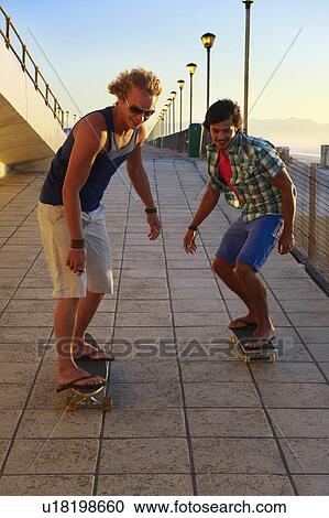 Young men skateboarding View Large Photo Image Stock Image - Young men skateboarding. Fotosearch