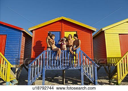 Young people hanging out by beach hut View Large Photo Image Picture - Young people hanging out by beach hut. Fotosearch