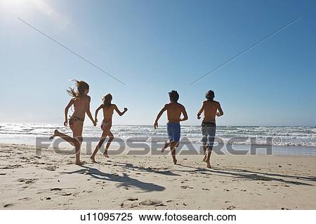 Young people running towards sea View Large Photo Image Stock Photography - Young people running towards sea. Fotosearch