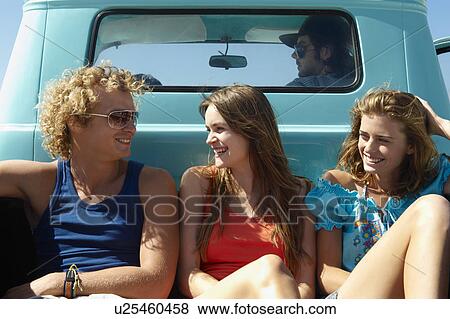 Stock Photo - Young people traveling in pickup truck. Fotosearch