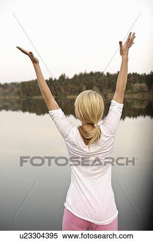 Young woman dancing by lake, stretching View Large Photo Image Stock Photography - Young woman dancing by lake, stretching. Fotosearch