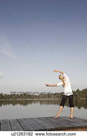 Young woman doing yoga exercise View Large Photo Image Stock Image - Young woman doing yoga exercise. Fotosearch