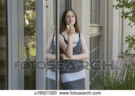 Young woman eating apple View Large Photo Image Stock Image - Young woman eating apple. Fotosearch