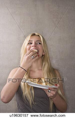 Young woman eats sandwich View Large Photo Image Stock Photo - Young woman eats sandwich. Fotosearch