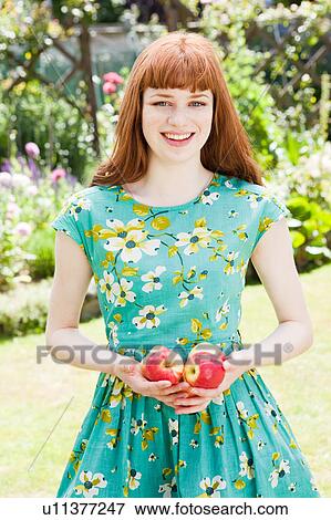 young woman holding apples. View Large Photo Image Stock Photo - young woman holding apples.. Fotosearch