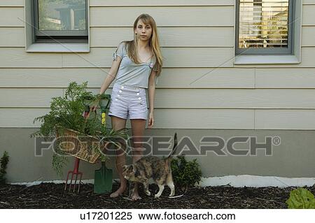 Stock Photography - Young woman holding basket. Fotosearch